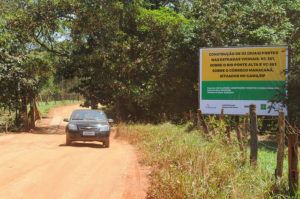 Na imagem, um carro em uma estrada de terra.